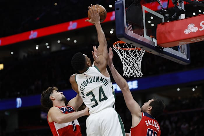 Milwaukee Bucks forward Giannis Antetokounmpo (34) dunks the ball over Washington Wizards forward Danilo Gallinari (88) and Wizards forward Deni Avdija (8)